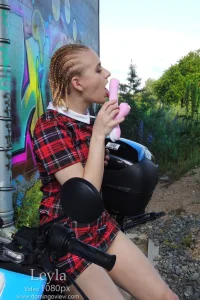Leyla uses a pink vibrator at graffiti wall on the electro scooter